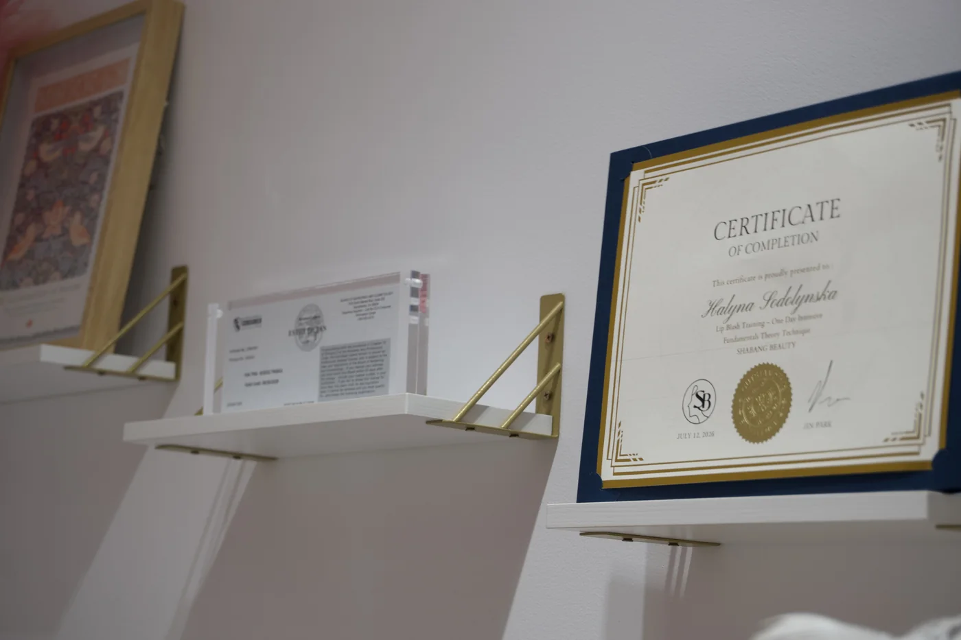 Certificates displayed on the studio wall